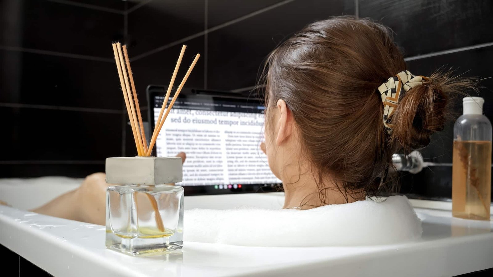 A Woman Takes a Relaxing Bath and Surfs the Web on Her Tablet Computer.